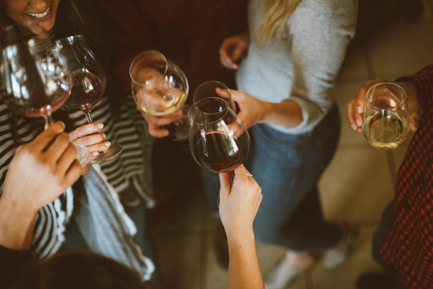 Wine glasses raised in a toast among friends